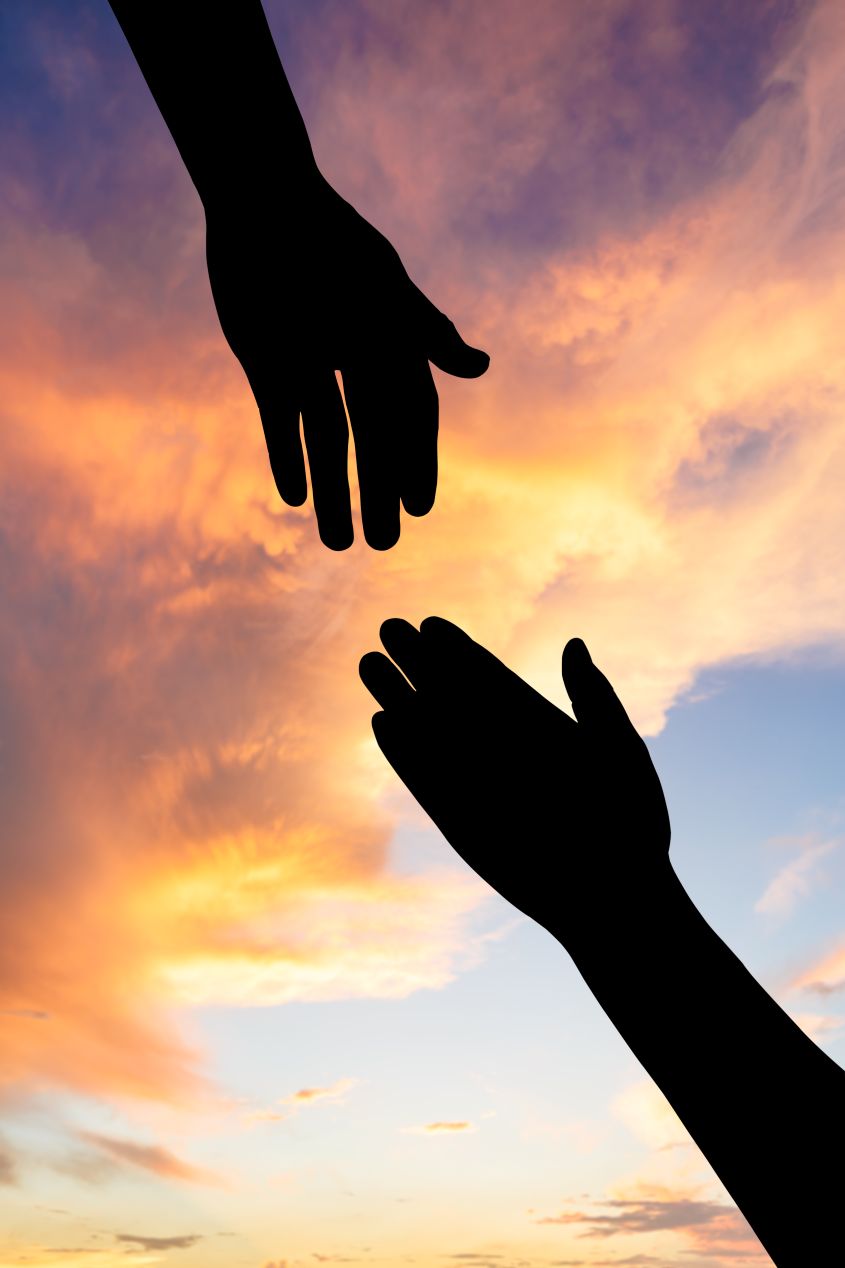 two hands reaching toward each other