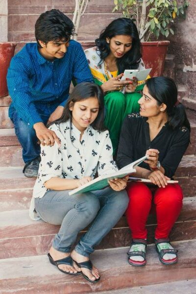 four young adults sitting on steps